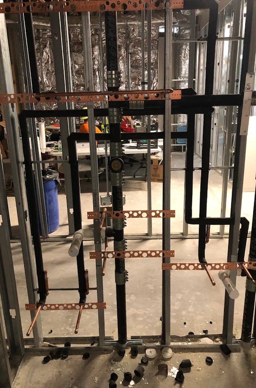 interior wall rough plumbing with copper and DWV lines